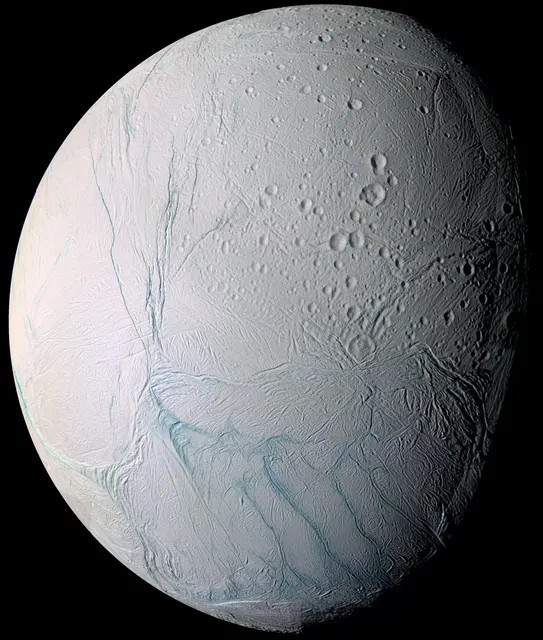 Enceladus, a bright white moon with bluish stripes near its south pole, in a Cassini mosaic