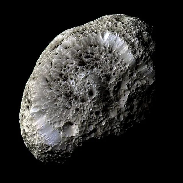 Hyperion, a potato-shaped moon with deep craters that make it look like a sponge, photographed by Cassini