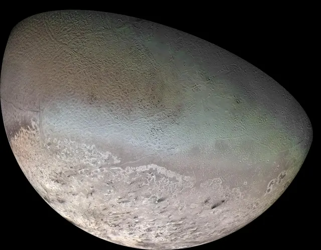 Triton, a pale moon in pinkish and greenish tones, in a Voyager 2 mosaic